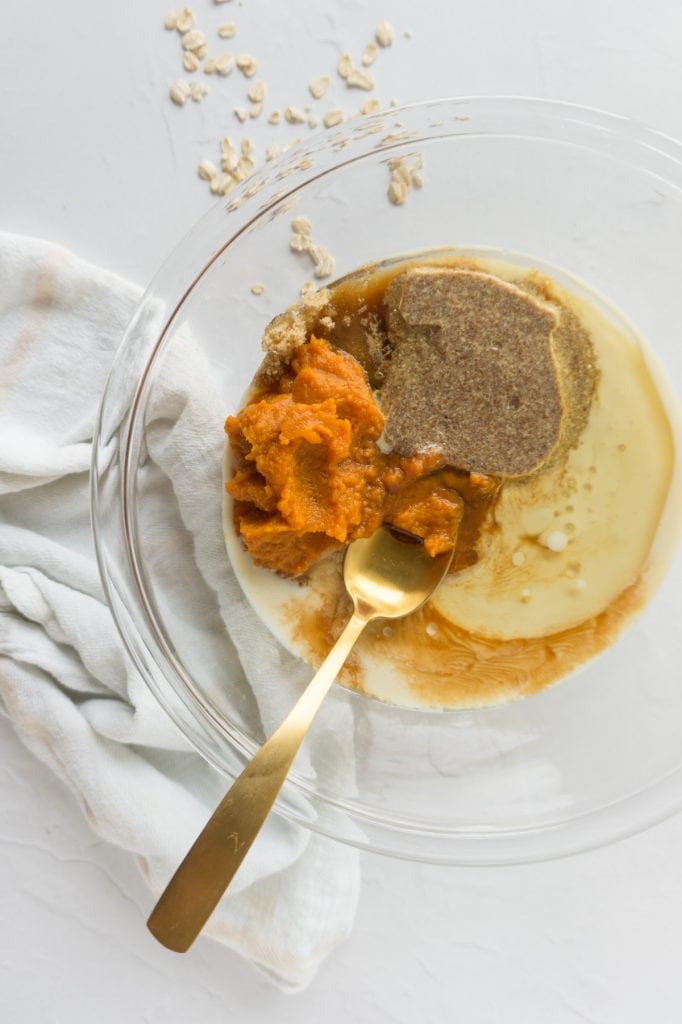 Bowl of wet ingredients with spoon for mixing