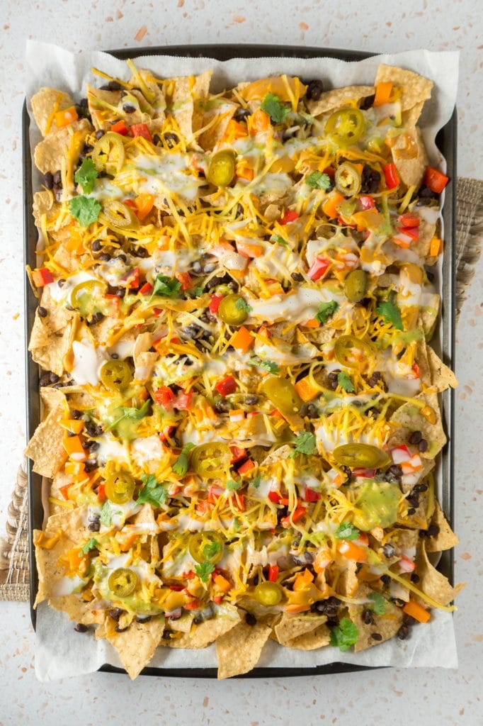 Sheet pan of nachos with toppings