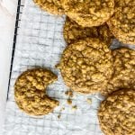 cookies on cooling rack with one cookie having a bite missing