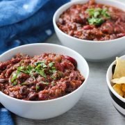 two bowls of hearty vegan chili topped with fresh cilantro