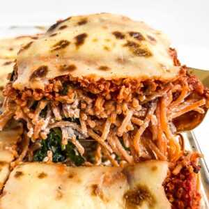 Close-up image of the side of a slice of baked spaghetti.