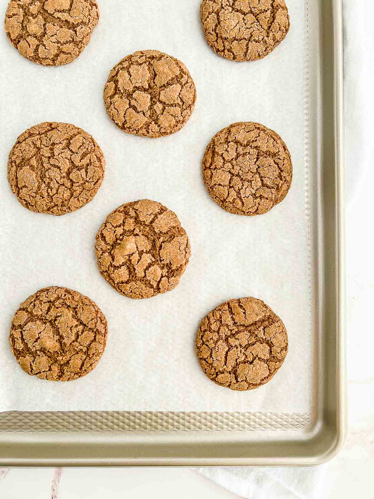 Baked vegan gingersnaps on a cookie tray.