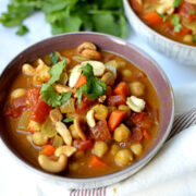 Bowl of chickpea curry topped with cilantro.