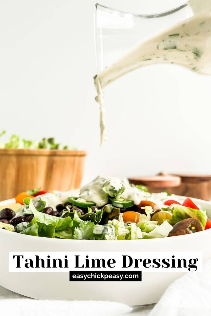 Tahini lime dressing being drizzled onto a salad with label for pinterest.