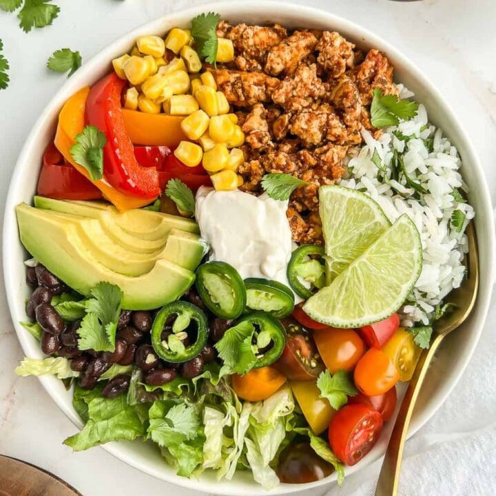 Tofu burrito bowl with a fork tucked in.