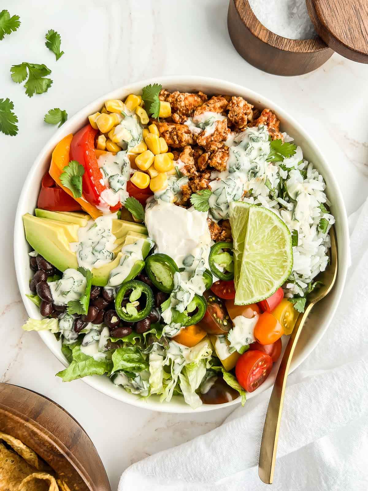 Tofu burrito bowl topped with tahini lime dressing.