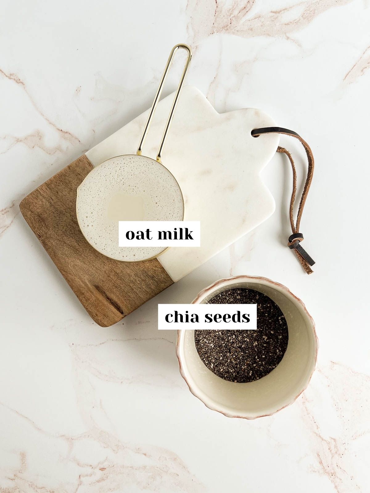 labeled oat milk and chia seeds on a small serving board.