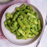 Warm plate of bright green broccoli pasta.