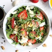 Salad with sliced strawberries and chiffonade basil.