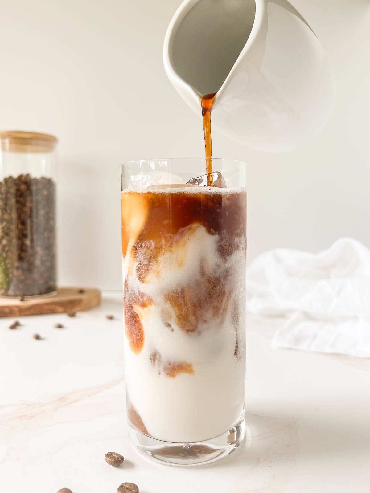 Pouring cold brew into the cold brew latte.