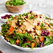 Butternut squash quinoa salad with creamy dressing on top.