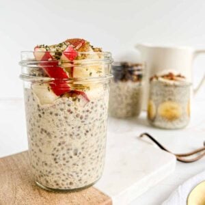 Chia pudding topped with apples, hemp hearts, and cinnamon on a serving board.