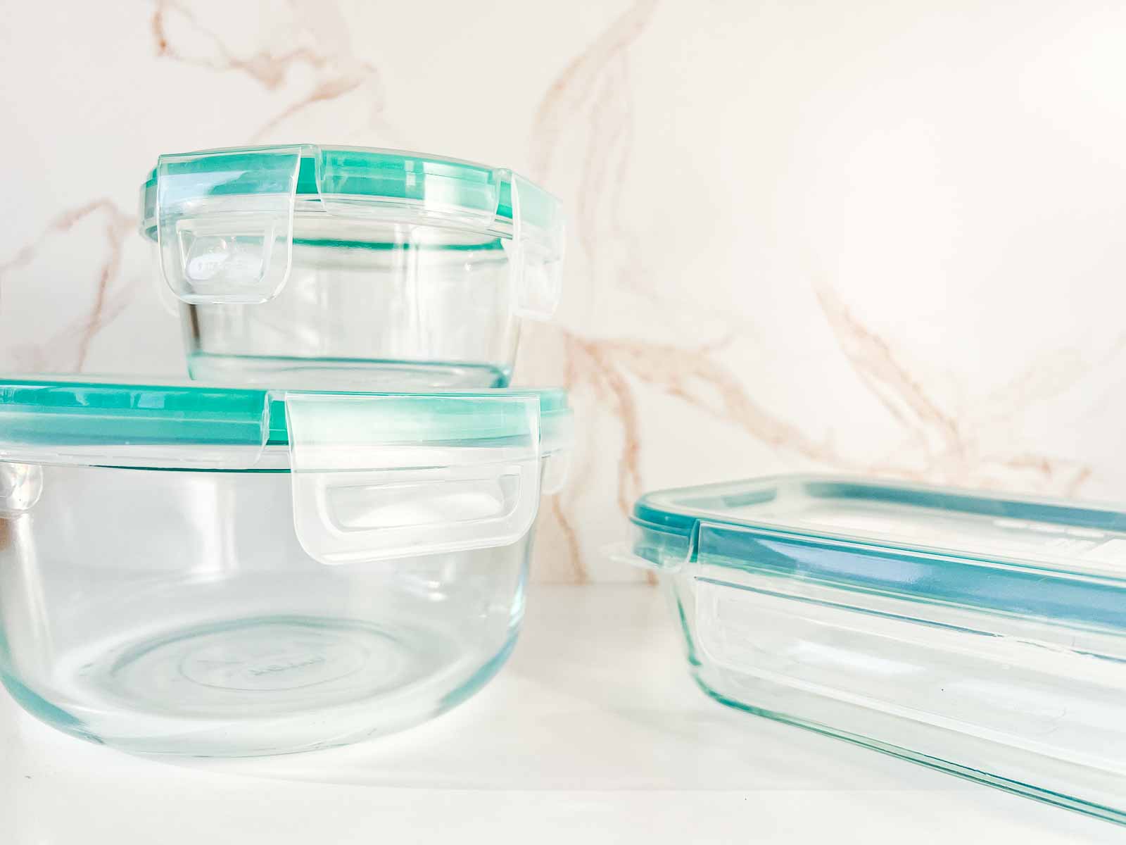 Three different sizes of Snapware glass containers.