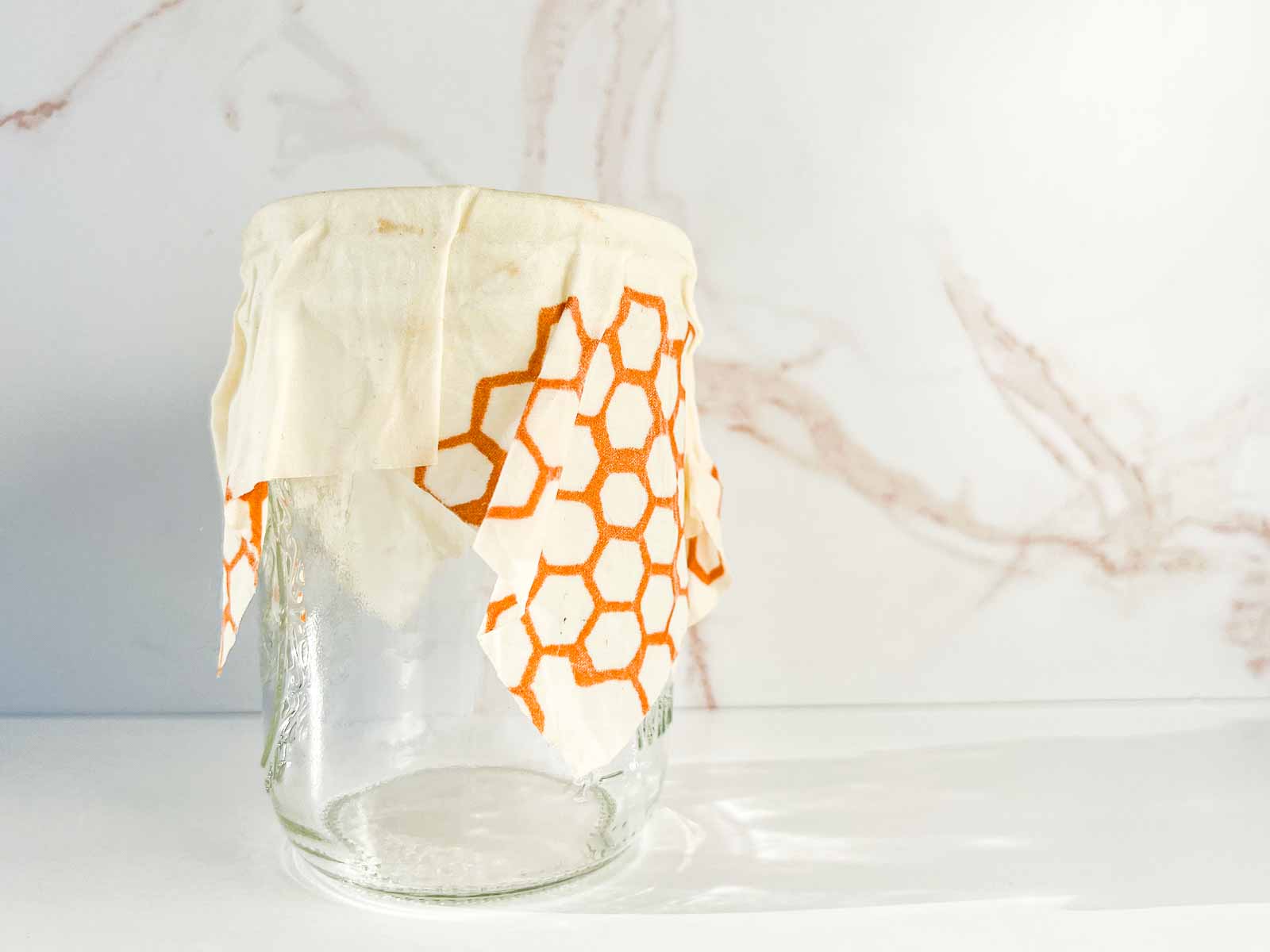 A jar with a Bee's Wrap over top.