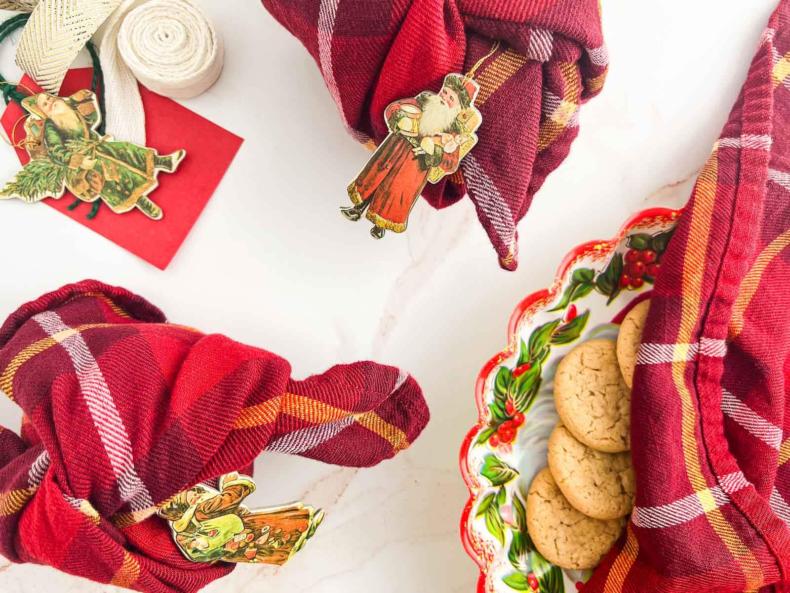 Cookies wrapped in cotton napkins, and cookies on a tray with a napkin draped over top.
