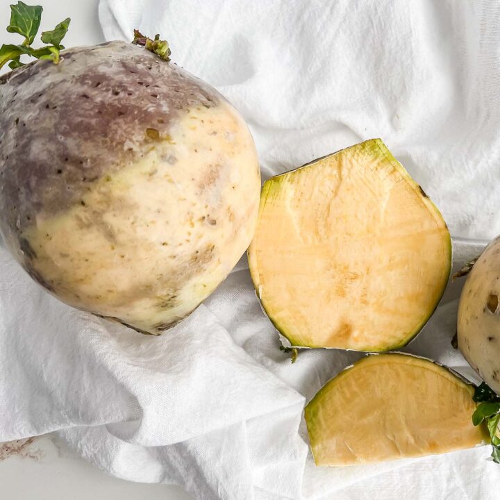 Two rutabaga, with the right sliced to show the inside.