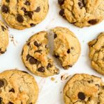 Cookie broken in half on a counter amongst other cookies.