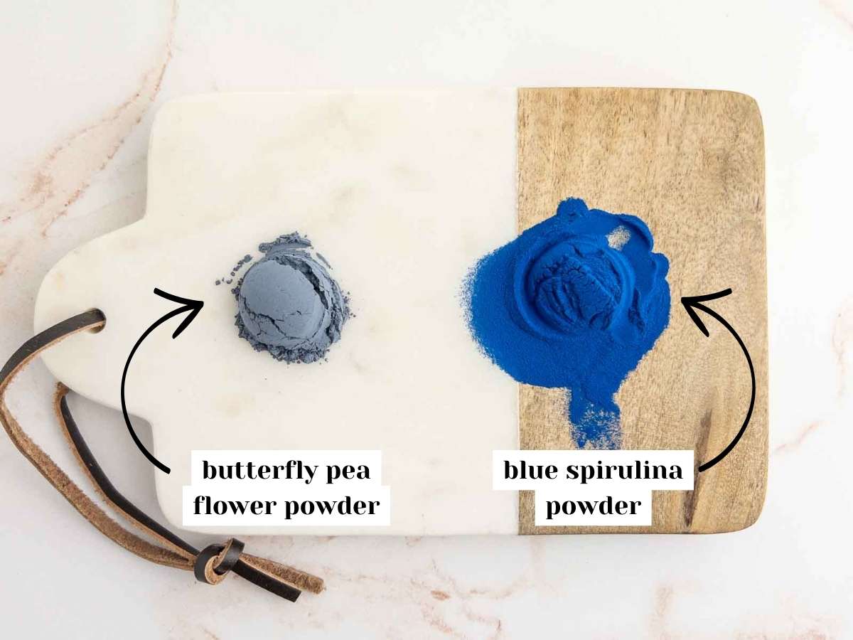A half teaspoon of butterfly pea flower and blue spirulina powder scooped on a serving board.