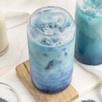 Iced butterfly pea matcha with swirls of blue matcha and white milk.